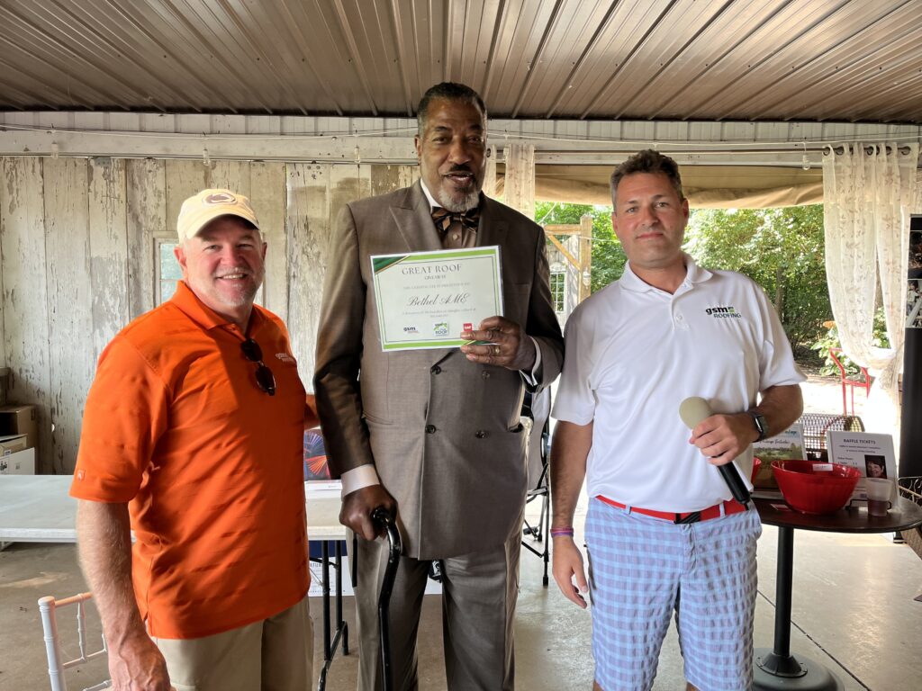 Bethel AME Cultural Center Accepting a check from the Gooding Group