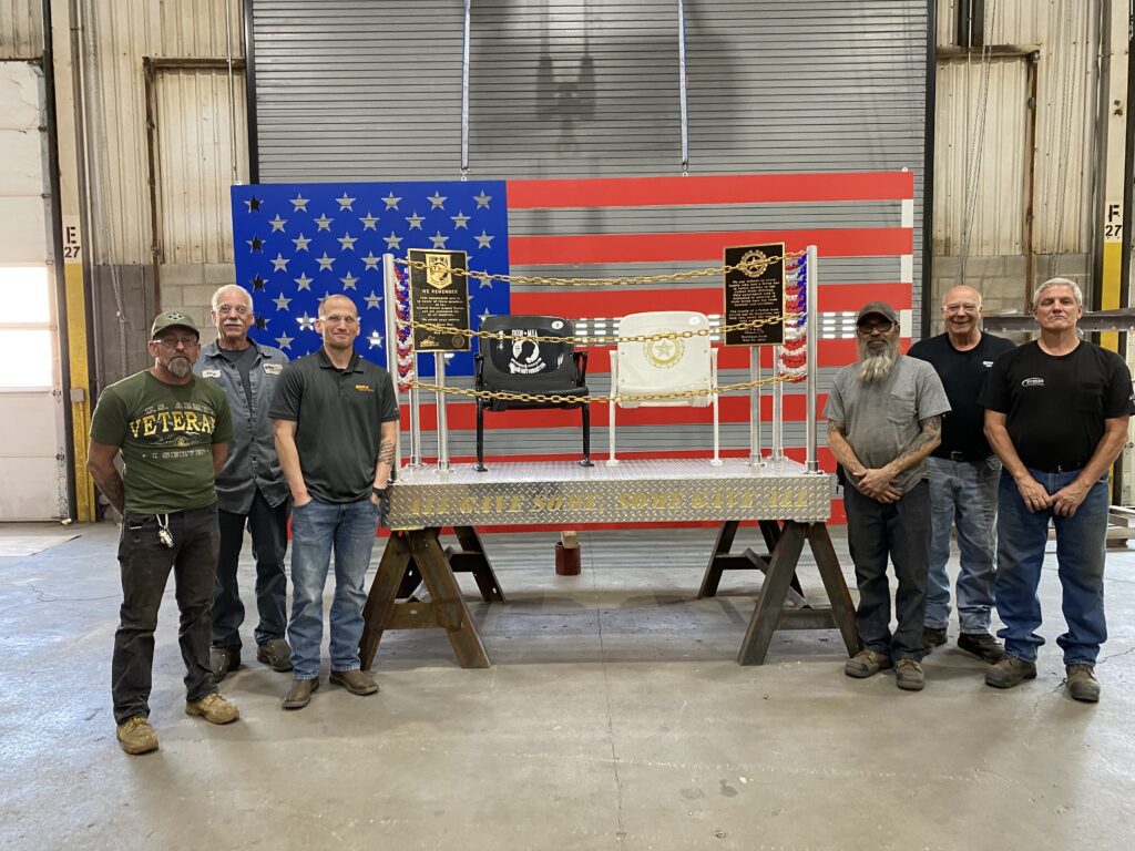 GSM Industrial veteran employees standing next to the veterans memorial fabricated by GSM Industrial