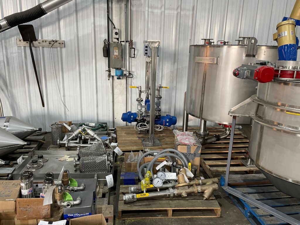 Pair of stainless steel slurry aging tanks with water jackets, 5 ft 8 in diameter, fabricated and pressure tested by GSM Industrial Lancaster PA for municipal water treatment facility