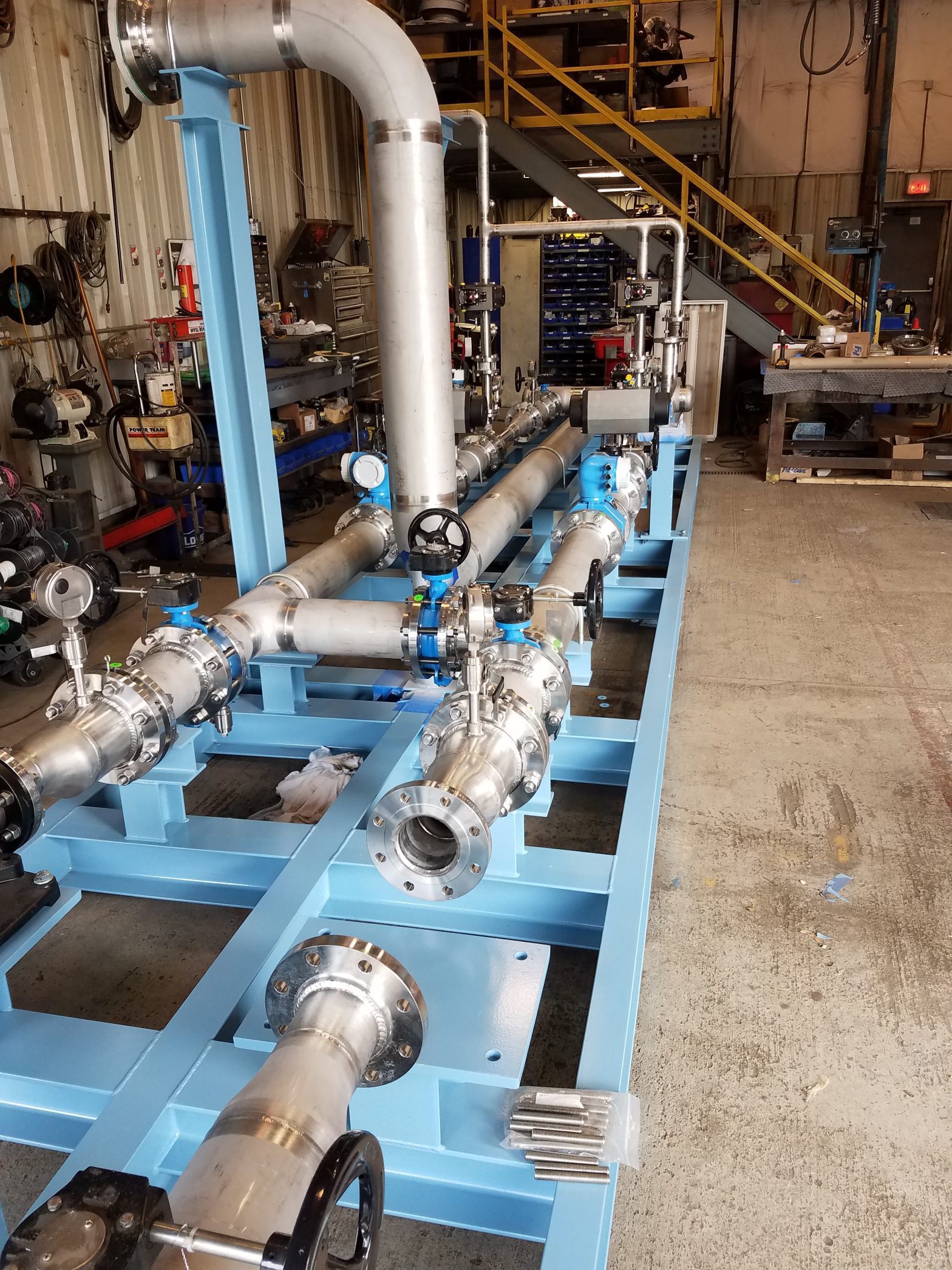 Complete assembly of GSM Industrial's ozone injection piping skid, featuring stainless steel piping mounted on a custom carbon steel frame