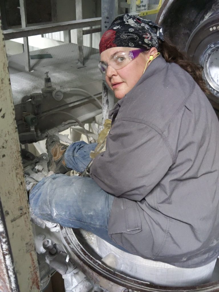 Beth working in the field welding