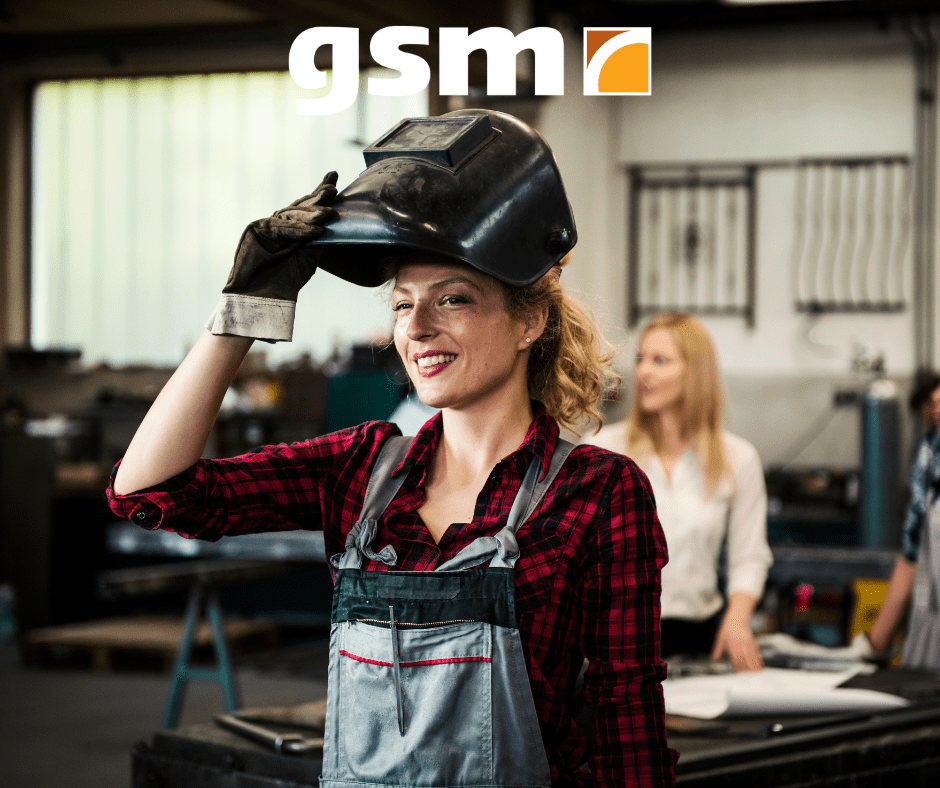 woman welder welding pipes in the shop