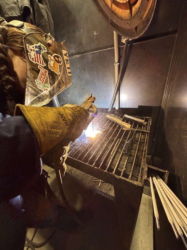 Caitlyn, a 15-year-old welder at GSM Industrial, working on a welding project during her internship.