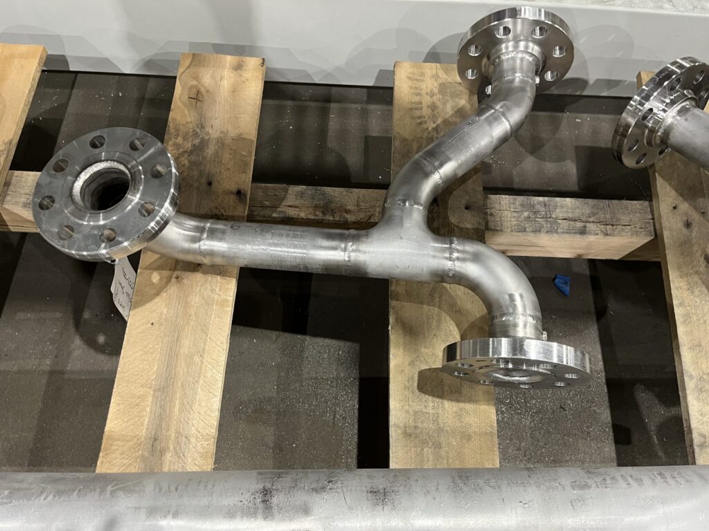 Custom-fabricated stainless steel Y-pipe fitting with flanged connections, designed for an industrial wastewater processing system.