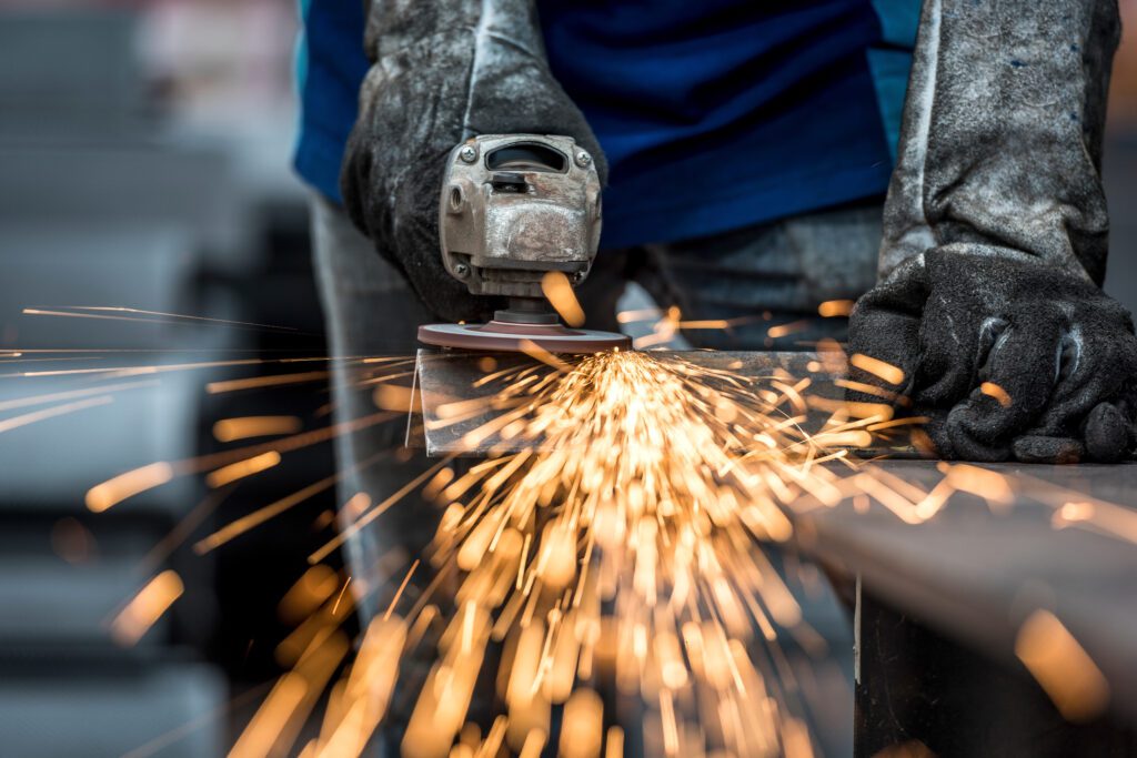 a metalworker grinding down metal