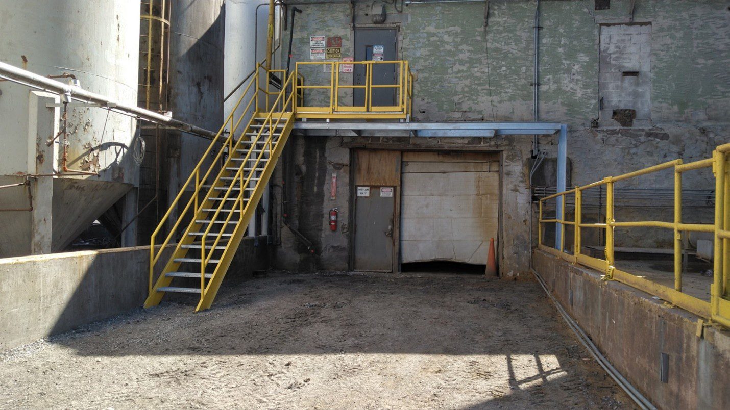 Newly installed GSM-fabricated stairs and platform with reinforced support legs