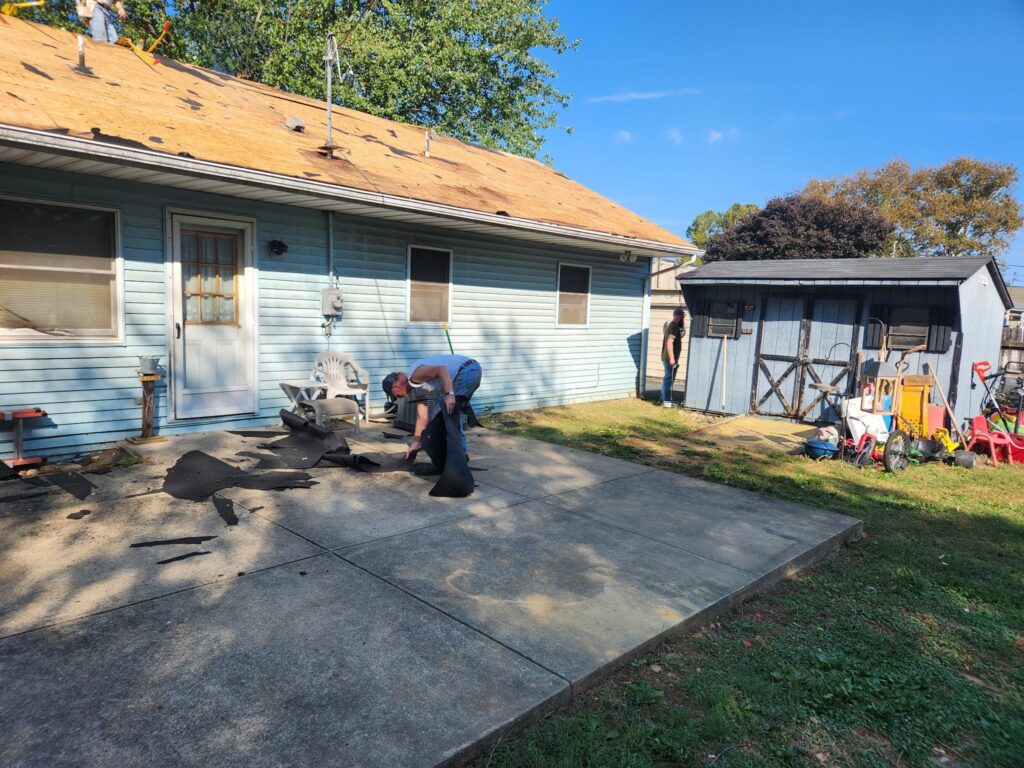 GSM Industrial and GSM Roofing volunteers removing old shingles and laying underlayment on a home in Ephrata, PA