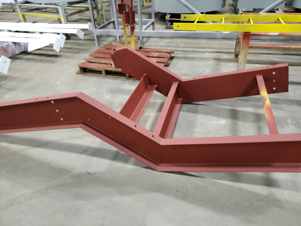 Red oxide primed structural steel frame fabricated to AISC standards in GSM Industrial’s shop