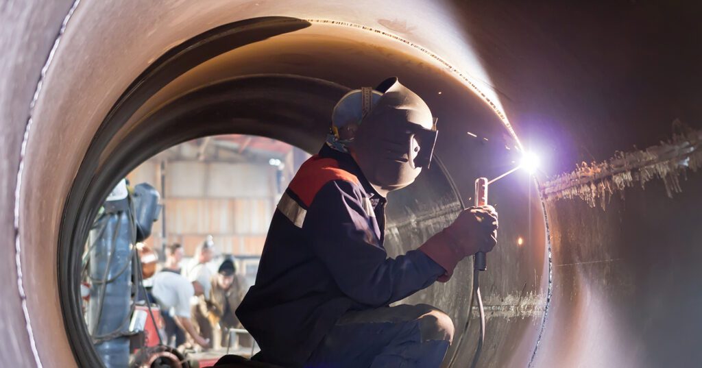 a welder making custom ductwork