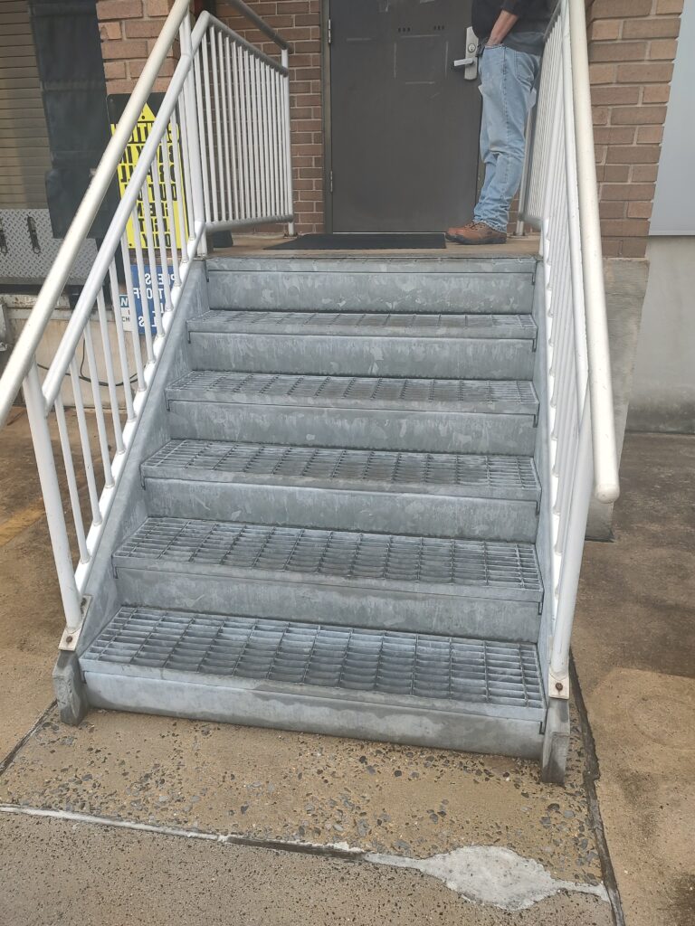 Exterior stair access before safety improvements, showing deteriorated stair surfaces and aging handrails.
